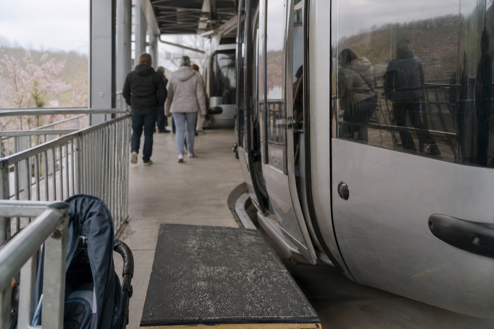 Close view of gondola cabins passing through a station platform area, no text, no logos, no people