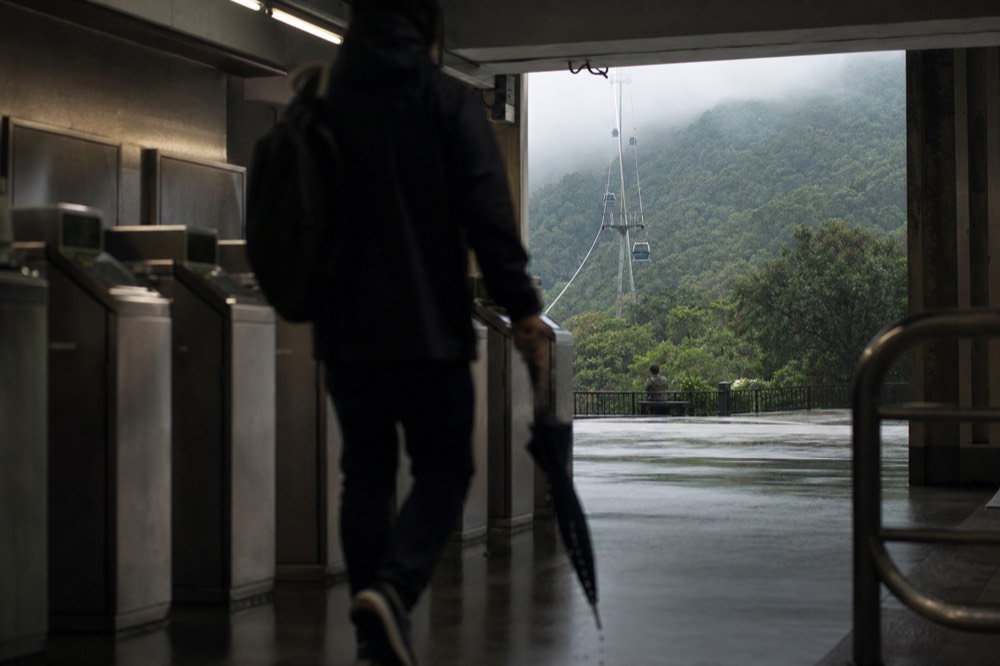 Empty gondola station platform with cabins parked in a line under the canopy, no text, no logos, no people