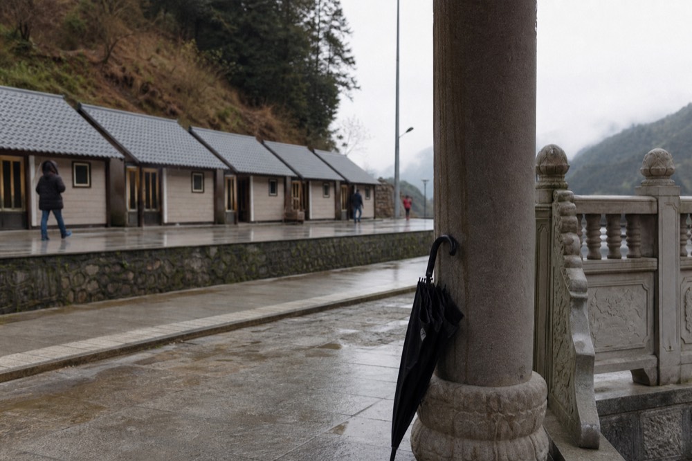 A row of gondola cabins at a hillside station platform, no text, no logos, no people