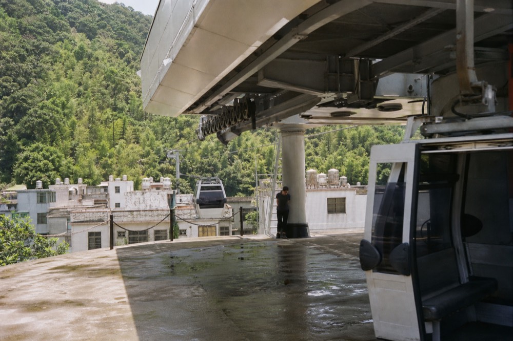 The lower gondola station building with cabins arriving at the platform, no text, no logos, no people