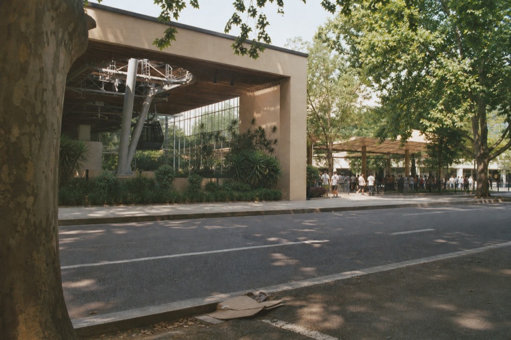 Taipei Zoo entrance gate with Maokong Gondola station in the background, no text, no logos, no people